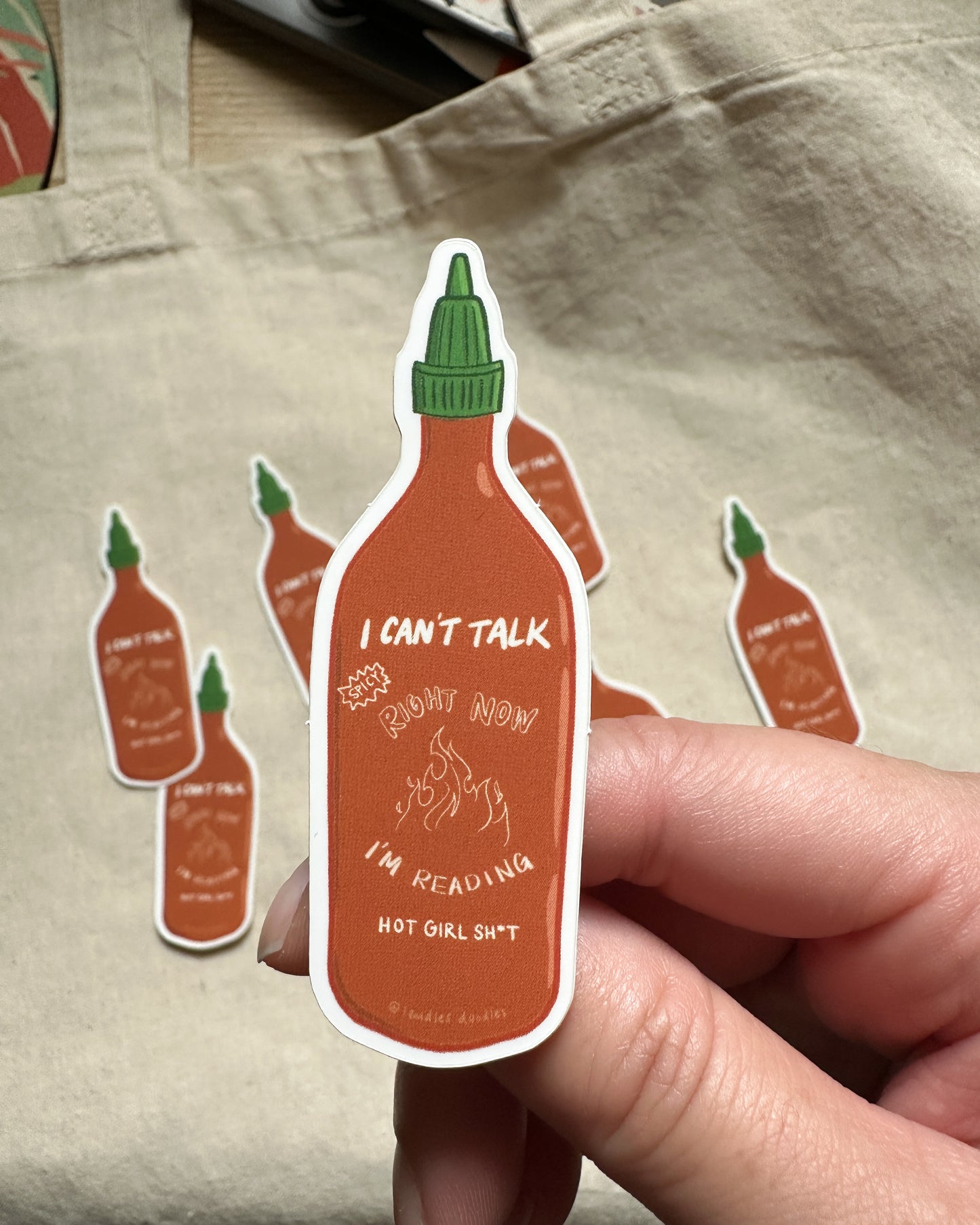 a 3 inch sticker of hot sauce with text saying "I can't talk right now" and "I'm reading hot girl sh*t"